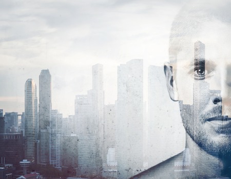 Double exposure Close-up portrait of a young attractive man and the city on the backgroundの写真素材