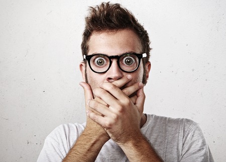Portrait of a surprised young man wearing eyeglassesの写真素材