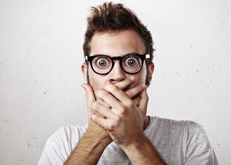 Portrait of a surprised young man wearing eyeglasses