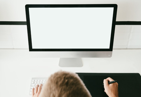 Mock up of generic design computer and workspace with man hands. Working on the projectの写真素材