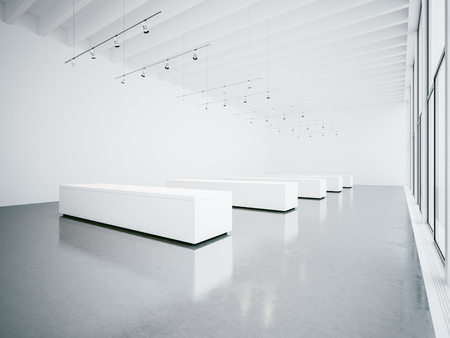Empty white gallery interior with concrete floor and panoramic windowsの写真素材