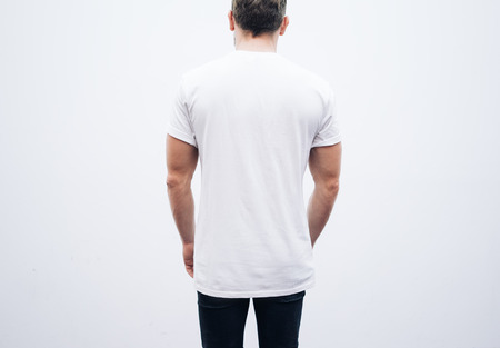 Man wearing blank tshirt and blue jeans on a white backgroundの写真素材