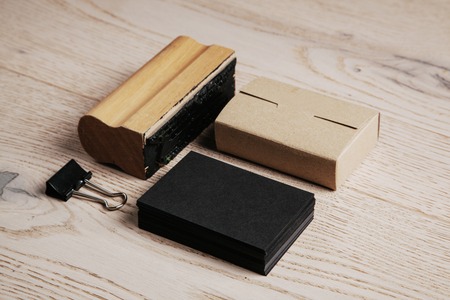 Set of black branding elements on the natural wood on a backgroundの写真素材