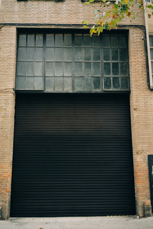 Part of black painted blinds of garage. Verticalの写真素材