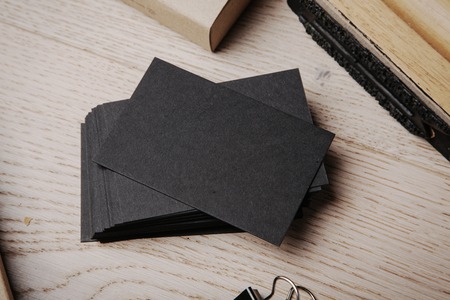 Set of blank business cards and branding office elements on the wooden backgroundの写真素材