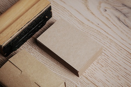 Blank business cards of kraft paper. Set of blank office elements on the wooden backgroundの写真素材