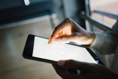 Tablet holding in female hands for text message. Horizontalの写真素材