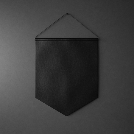 Black pennant hanging on the wall on black background. Squareの写真素材