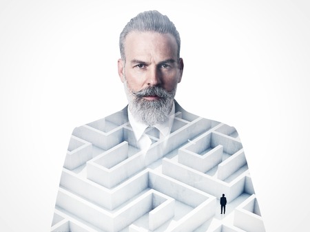 Businessman wearing modern suit and looking on the camera. Double exposure photo of the labyrinth