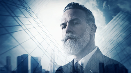 Close-up portrait of businessman. Photo of double exposure of panoramic view at sunriseの写真素材