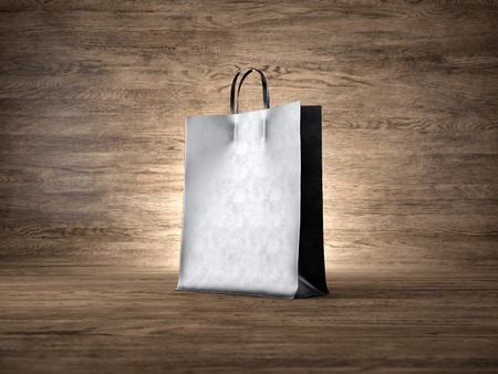 Black shopping bag on the wood background. Focus on the shopping bag. Horizontalの写真素材