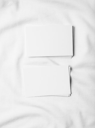 Closeup of white business cards on white tshirt.の写真素材