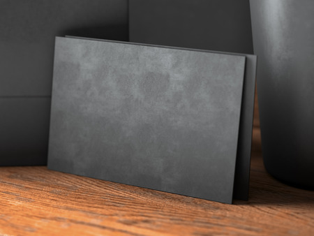 Closeup of blank black business cards on natural wood table.の写真素材