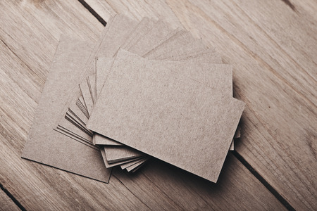 Photo of blank and craft business cards on natural wood table. Horizontalの写真素材