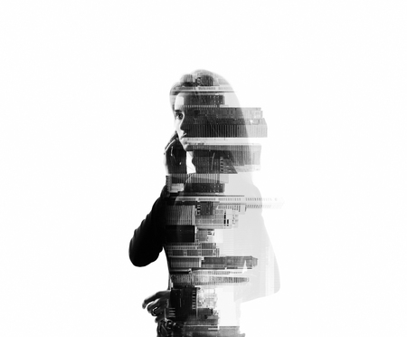 Portrait of young woman holding her smartphone in a hands. Isolated, double exposure, bwの写真素材