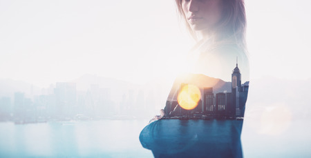 Photo of businesswoman. Double exposure, city on the background. Blurred, horizontalの写真素材