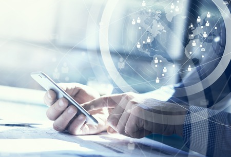 Business concept. Businessman working generic design laptop and smartphone. Worldwide connection technology interface, horizontal Business concept. Businessman working generic design laptop and smartphone. Worldwide connection technology interface, horizontal