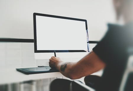Mock up of generic design computer and workspace with man hands. Working on the projectの写真素材