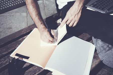 Closeup photo student writing textbook message. Studying at the University, working project, ...