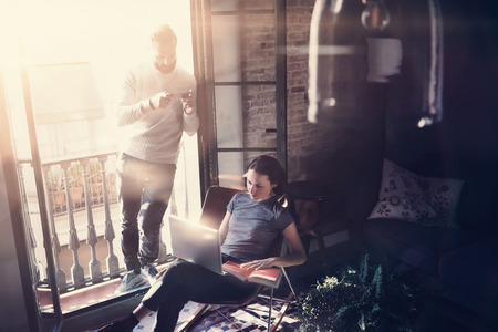 Couple professionals work together. Photo woman and bearded man working with new startup project in...