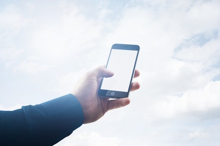 Double exposure photo businessman holding modern smartphone hand, touching empty white screen....