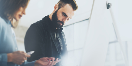 Creative managers meeting. Photo art director working with designer new startup project. Idea, analyze marketing plans. Blurred background, light effects,の写真素材