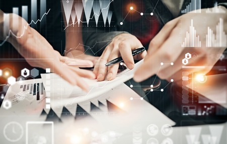 Businessmans crew working banking investment project modern office.Man holding pen for sign documents. Worldwide connection technology icons,stock exchanges graphics interface.の写真素材