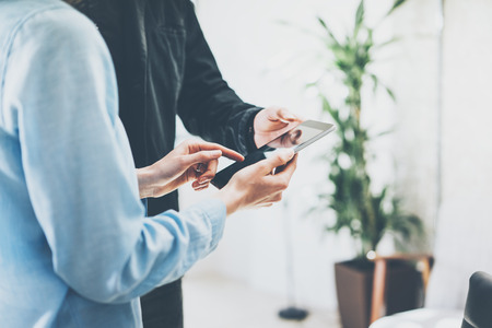 Finance department work process.Photo woman showing reports modern tablet screen with reflections. Bank manager holding electronic device hand.New business project startup. Film effectsの写真素材