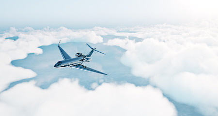 Photo of black luxury generic design private jet flying over the earth. Empty blue sky with white...