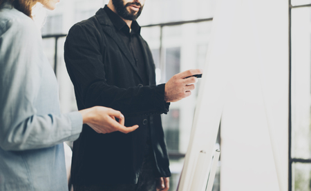 Business meeting office.Closeup photo men writing statistic info chart board.Photo account manager crew working with new startup project.Idea presentation,analyze marketing plan.Blurred,filmの写真素材