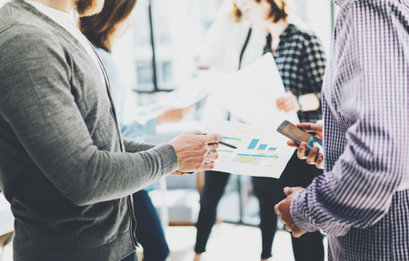 Business meeting office.Closeup photo documents holding hands. Photo account managers crew working with new startup project.Idea presentation, analyze marketing plans.Blurred, film effect.の写真素材