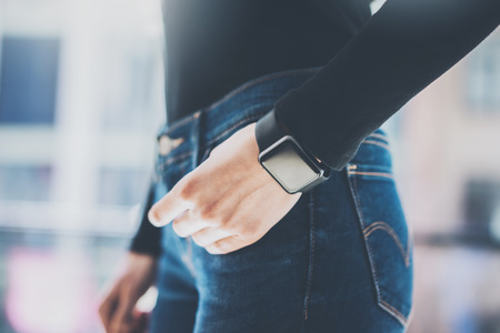 Photo Woman Working Modern loft,using generic design smart watch.Female Hands Touching screen...