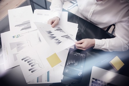 Risk management work process.Photo banker holding statistics document hands.Using electronic...