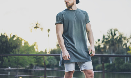 Photo Bearded Muscular Man Wearing Grey Blank t-shirt and shorts summer time. Green City Garden And...
