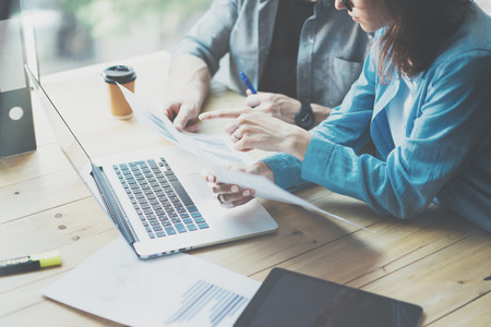 Sales Department Work Process.Photo traders reading market report modern laptop.Using electronic devices.Working graphics,stock exchanges data reports.Business project startup.Horizontal,film effect.の写真素材