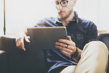 Bearded marketing specialist working digital tablet modern Interior Design Loft Office.Man relax...