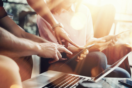 Young Coworkers Team Analyze Meeting Report Electronic Gadgets.Businessmans Startup Online Marketing Project.Creative People Making Great Work Decisions Office.Tablet Laptop Closeup Blurred Backgroundの写真素材