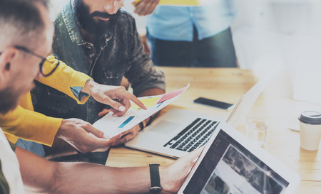 Startup People Brainstorming Process.Coworkers Making Great Decisions.Young Bearded Hipsters Business Team Discussion Corporate Work Concept.Sales Manager Analyze Project Wood Table Modern Officeの写真素材