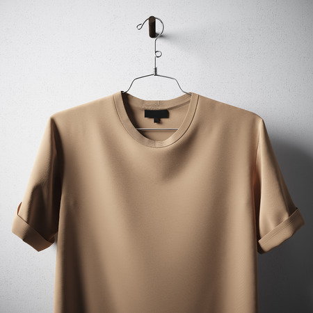 Closeup Blank Brown Cotton Tshirt Hanging Center Concrete White Empty Background.Mockup Highly Detailed Texture Materials.Clear Label Space for Business Message. Square. 3D renderingの写真素材