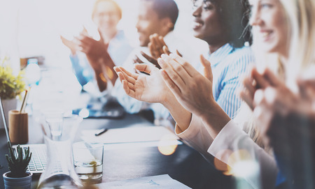 Photo of partners clapping hands after business seminar. Professional education, work meeting, presentation or coaching concept.Horizontal,blurred backgroundの写真素材