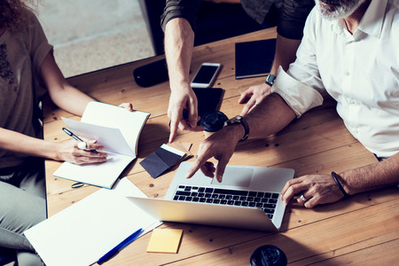 Concept of presentation new business project.Male hands pointing to screen modern laptop.Teamwork process in coworking office.Horizontalの写真素材
