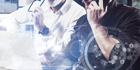Concept of digital screen,virtual connection icon,diagram, graph interfaces.Bearded young man using...