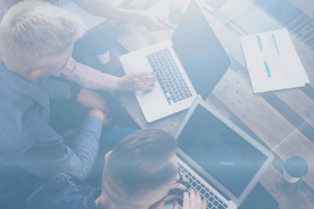 Top view of young team of coworkers making great work discussion in modern office.Man discussing with colleagues stratup project.Business people meeting concept.Horizontal, blurred background.の写真素材