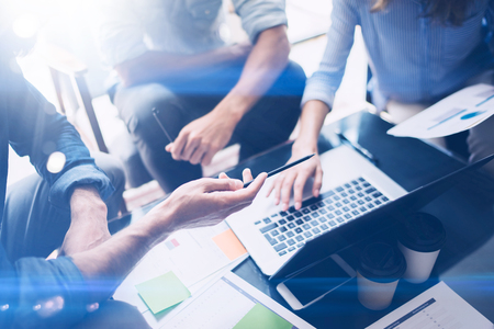Closeup view of Teamwork process.Young coworkers work with new startup project in office.Analyze document, plans.Modern laptop on wood table, papers, documents.Horizontal,cropped.の写真素材