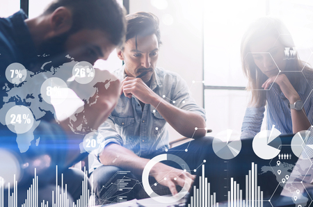 New business project startup.Group of young coworkers discussing ideas in modern office.Concept of digital diagram,graph interfaces,virtual screen,connections icon on blurred background.の写真素材