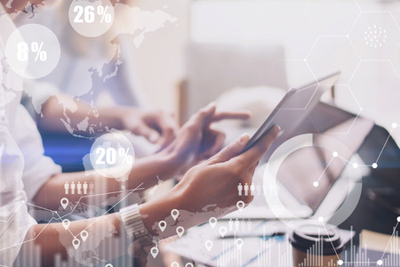 Concept of digital diagram,graph interfaces,virtual screen,connections icon on blurred background.Business meeting process.Female hand pointing to touch tablet display.Horizontal.の写真素材