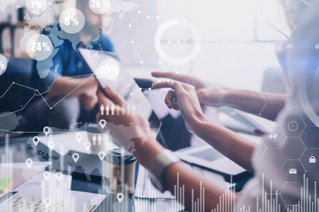 Concept of digital diagram,graph interfaces,virtual screen,connections icon on blurred background.Business meeting process.Woman pointing to touch tablet display.Horizontal.Cropped.の写真素材