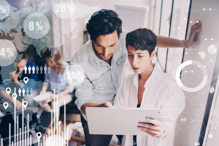 Concept of digital diagram,graph interfaces,virtual screen,connections icon on blurred background.Coworking team meeting.Group of colleagues working with startup project in modern office.の写真素材
