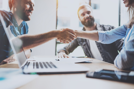Business partnership handshake concept.Photo two coworkers handshaking process.Successful deal after great meeting.Horizontal, blurred background.の写真素材