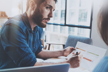 Hispanic young businessman working with new client at sunny office.Blurred background. Horizontalの写真素材